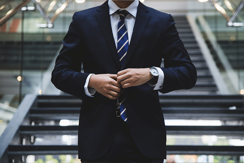 A person wears a suit and tie.