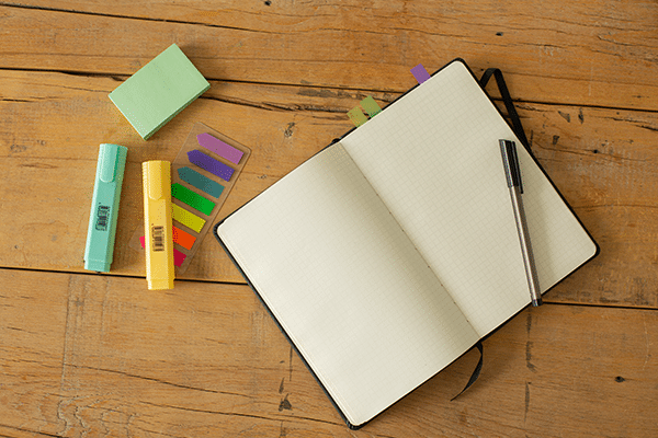 A variety of office supplies, stationery, instruments, pens, general supplies, writing implements, and paper products are arranged in an indoor design.
